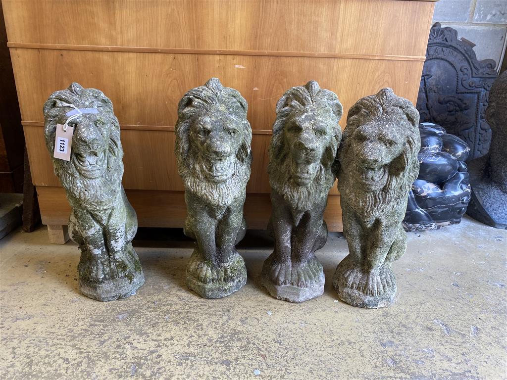 A set of four reconstituted stone lion garden ornaments, height 52cm